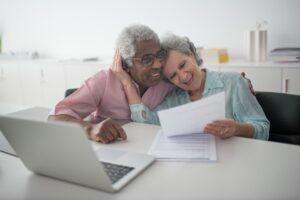 Couple looking at dental insurance and smiling at how much it covers